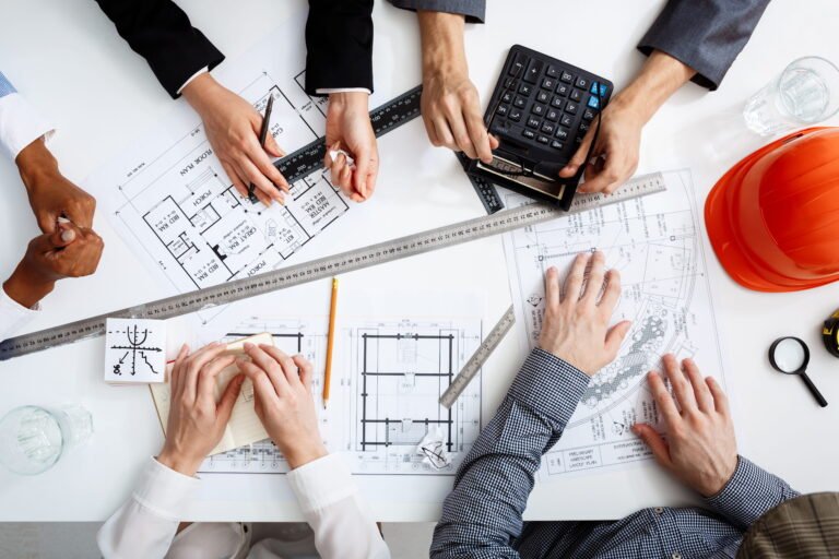 Estimator checking construction drawings and cost calculations
