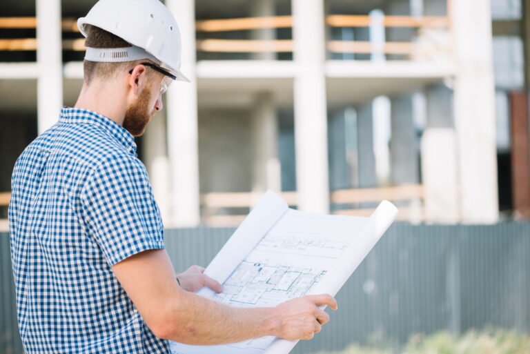 Estimator reviewing construction blueprints